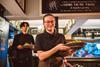 Restaurant staff carrying plated meals during busy pub dining service - stock photo