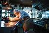 Hospitality worker in kitchen GettyImages-1158191245