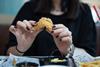 Woman eating fried chicken - Getty STOCK