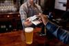 Pub_customer_payment_GettyImages-1430548805