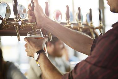 Close-up of bartender making cask beers at bar - stock photo