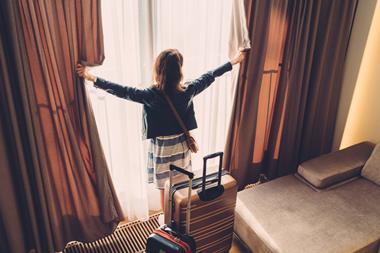 Tourist woman just arriving in the hotel room - stock photo