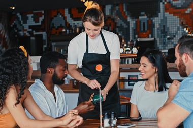 Paying bill in restaurant GettyImages-1355306744