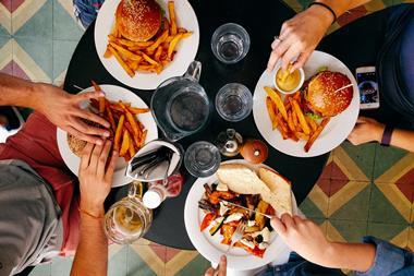 people eating burgers and chips meal restaurant