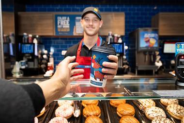 Greggs - Worker serves a coffee to a customer during the festive period