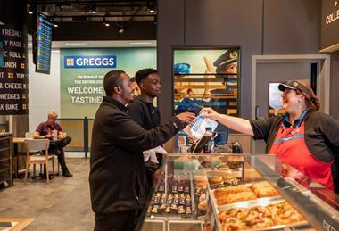 Two customers being served at the Greggs Gatwick store