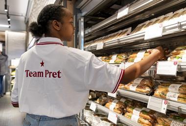 A worker stocks a chiller with sandwiches at a Pret shop in the US  2100x1400