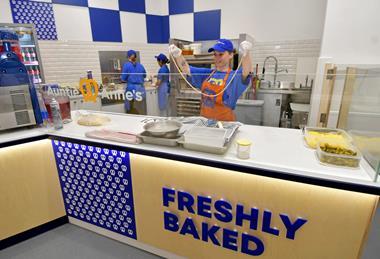 An Auntie Anne's staff member prepares a pretzel to be fresh baked at the Watford store  2100x1400