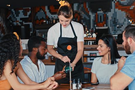 Paying bill in restaurant GettyImages-1355306744